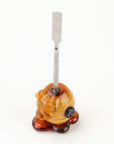 Top view of Honey Dab Concentrate Tool highlighting lampwork handle and metal dabber tip