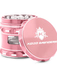 Rose gold herb grinder with 'Kozo Grinders' logo on a white background