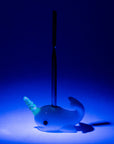UV reactive Radioactive Narwhal Wax Tool glowing under blacklight